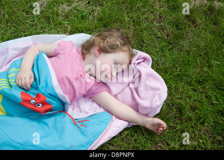 Little girl napping outdoors Stock Photo