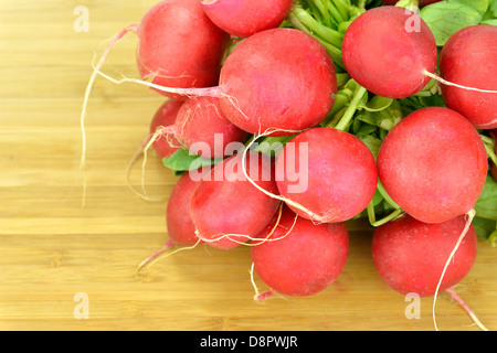 Close-up of a bunch of radishes on a board Stock Photo