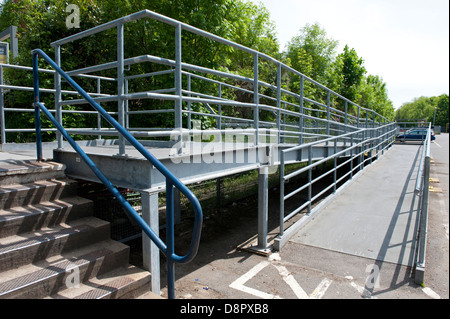 A large and lengthy ramp installed at Chorleywood railway station to enable wheelchair passengers to gain access to the platform Stock Photo