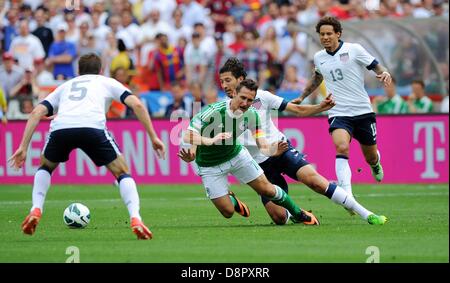 Miroslav Klose (2nd left) of Germany and Omar Gonzalez of USA vie for the ball during the international friendly soccer match between USA and Germany at Robert F. Kennedy memorial stadium in Washington (District of Columbia), USA, 02 June 2013. Photo: Thomas Eisenhuth/dpa Stock Photo