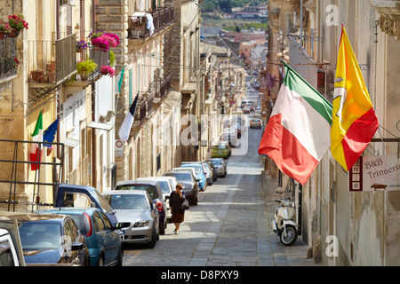 Italian and sicilian flag on the street of Noto town, Sicily, Italy UNESCO Stock Photo