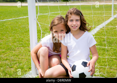 Soccer football kid girls playing on sports outdoor field Stock Photo