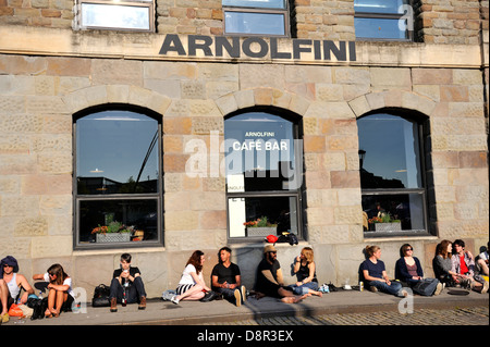 Arnolfini art gallery Bristol, people sitting on pavement outside enjoying the sun Stock Photo