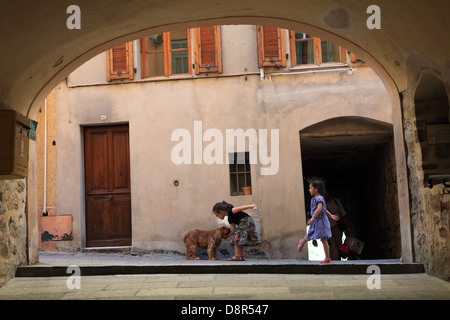 Children playing in the street in the perched village of Castellar near Menton. Stock Photo