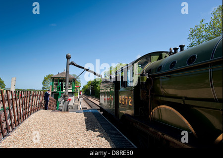 Steam train at water tower for a fill up. Stock Photo