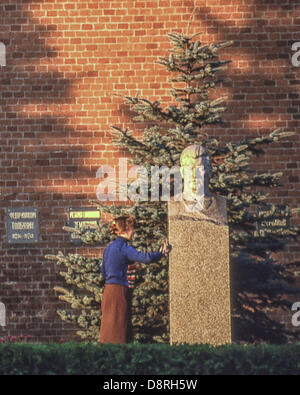 May 9, 1984 - Moscow, RU - A cleaning woman polishes the bust of Soviet Dictator Joseph Stalin (1878 - 1953), that marks his last resting place, a grave in the Kremlin Wall Necropolis behind Lenin's Mausoleum in Moscow His body was originally placed in Leninâ€™s Mausoleum, but in 1961 it was removed and buried here. (Credit Image: © Arnold Drapkin/ZUMAPRESS.com) Stock Photo