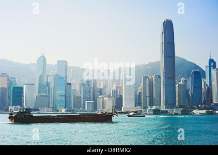 Industrial barge in front of Hong Kong financial district Stock Photo