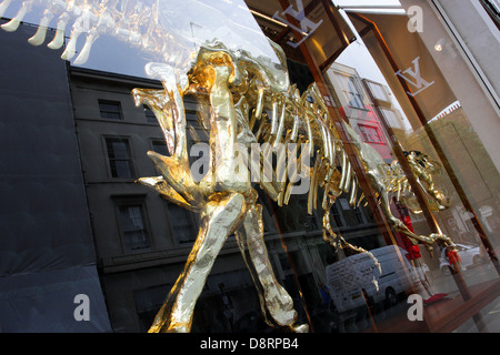 louis vuitton's gilded dinosaur skeleton window installation