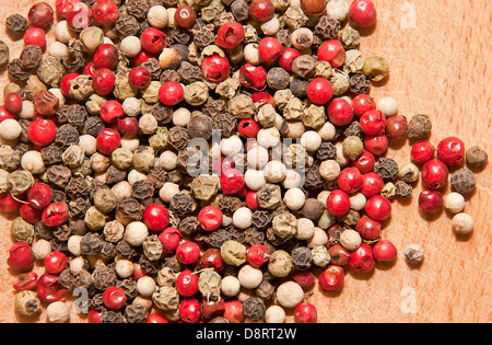 Image of black, green, white and red pepper on wood background Stock Photo