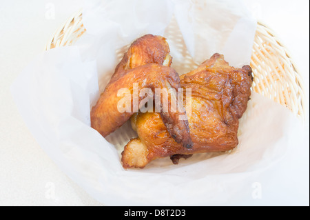 The pieces of grilled chicken in a basket. Stock Photo