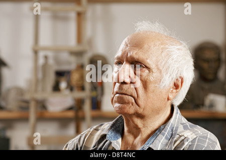 Elderly man in sculptors workshop Stock Photo