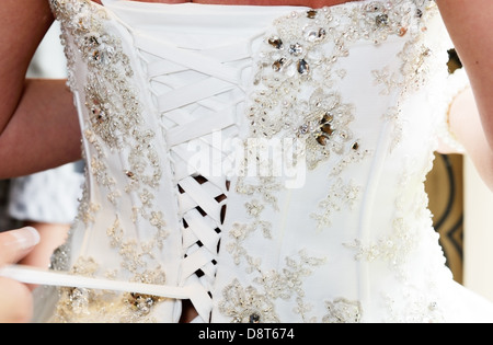 Brides dress back being done up closeup detail Stock Photo