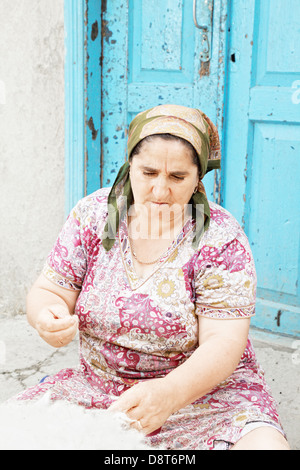 Woman cleaning wool Stock Photo