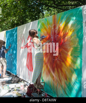 Artists work on their canvas' at the Howl! Festival's 'Art Around the Park' around Tompkins Square Park in New York Stock Photo