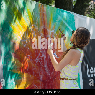 Artists work on their canvas' at the Howl! Festival's 'Art Around the Park' around Tompkins Square Park in New York Stock Photo