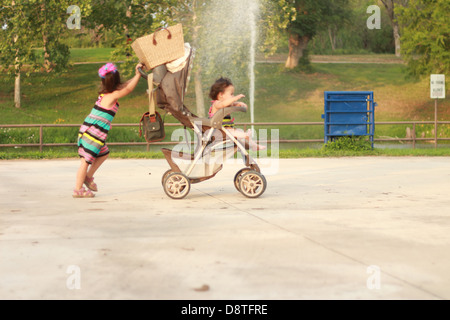 Windy day with waterfall hitting two young sisters walking in the park Uvalde TX / tx / Texas Stock Photo