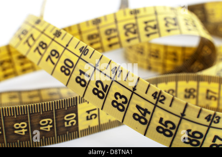 A centimeter tape measure arranged in a spiral shape Stock Photo - Alamy