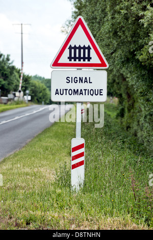 A French sign warning of an automatic railway crossing Stock Photo