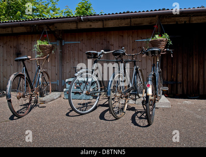 Vintage push bicycles on old fashioned concrete bike stands Stock Photo