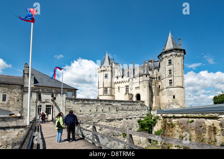 Tourists admiring the historic Château de Saumur in the Loire valley, France. From the bridge leading to the castle. Stock Photo