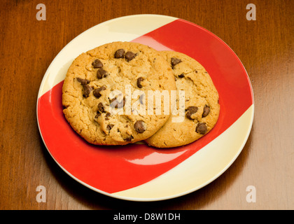 Two chocolate chip cookies on plate Stock Photo