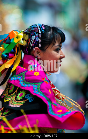 A girl dancer (danzante) performs in the religious parade within the Corpus Christi festival in Pujilí, Ecuador. Stock Photo