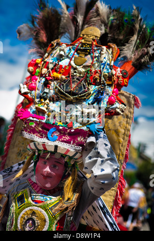 A dancer (danzante) performs in the religious parade within the Corpus Christi festival in Pujilí, Ecuador. Stock Photo