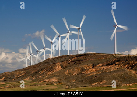 A row of nine wind turbines turning on a hill near Zaragoza, Spain Stock Photo