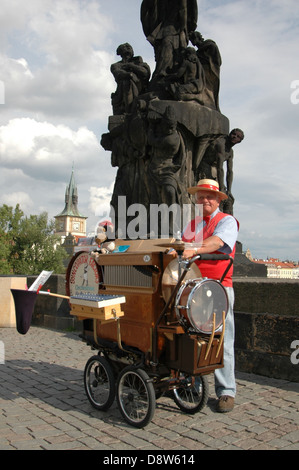 A one man band busker performing in Charles Bridge or Karluv Most Prague Czech republic Stock Photo