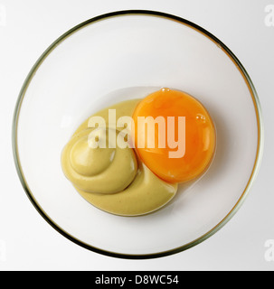 Egg yolk and mustard in a small bowl Stock Photo