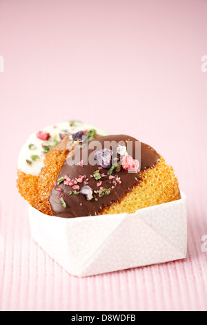 Cookies coated with chocolate and crystallized flowers Stock Photo