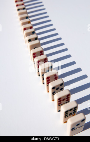 Close up of domino tiles in row on white background, studio shot Stock Photo
