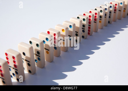 Close up of domino tiles in row on white background, studio shot Stock Photo