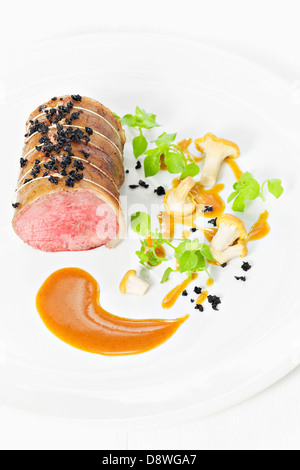 Spanish pork fillet with chanterelles and finely chopped black trumpet mushrooms Stock Photo