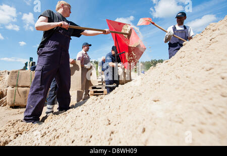 Volunteer helpers of the fire brigade fill sandbags in a gravel pit near Tramm, Germany, 05 June 2013. The Elbe is feared to rech record water levels in Lower Saxony towards the weekend. Photo: PHILIPP SCHULZE Stock Photo