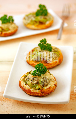 Tartlets with leek and blue cheese. Recipe available. Stock Photo