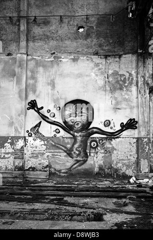 Mural in abandoned factory. - Alien Stock Photo