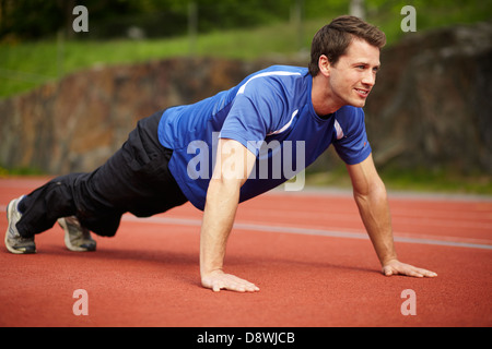 Male athlete doing push-ups Stock Photo