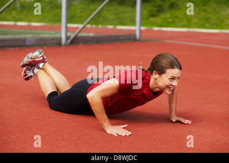 Female athlete doing push-ups Stock Photo