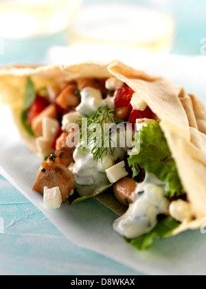 Chicken,tomato,feta and lettuce pitta bread sandwich with white yoghurt sauce Stock Photo