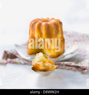 Fennel,citrus fruit and dried apricot sweet Cannelés Stock Photo