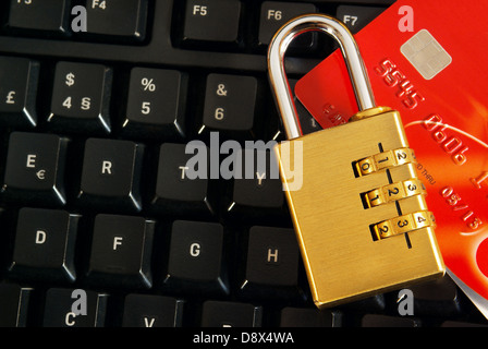 Shopping online concept with a credit-card and padlock over a computer keyboard Stock Photo