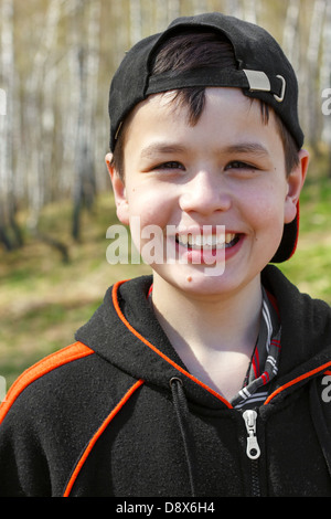 close-up portrait of laughing little boy in spring birch grove Stock Photo