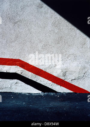 Red and black stripes on a white wall. Stock Photo