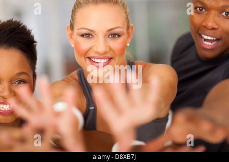 exciting fitness team reaching out Stock Photo