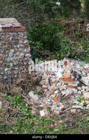 Flint stone wall, partially collapsed. Hickling Hall, Hickling , Norfolk. Awaiting repair and re-build. Broadland, Norfolk. Stock Photo