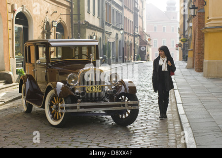 Oldtimer car Essex Super Six and young woman on Old Town in Warsaw, Poland Stock Photo