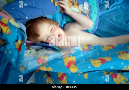 A child playing in the bed, Sweden. Stock Photo