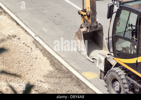 Scoop on a road construction site. Stock Photo