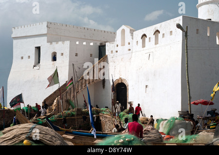 fishing boats and cape coast castle, cape coast, ghana, africa Stock Photo